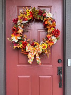 a red door with a wreath on it