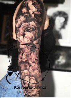 a woman's arm with flowers on it