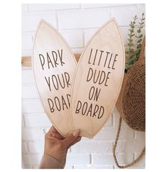 two wooden paddles with the words park your boat on board written in black ink