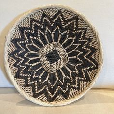 a black and white basket sitting on top of a table