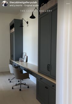 a home office with gray cabinets and white walls