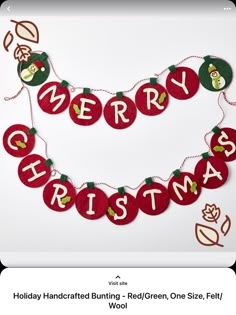 a merry christmas banner hanging from a string on a white background with red and green ornaments