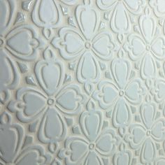 the back side of a white wall with an intricate design on it's surface