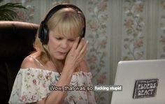 a woman sitting in front of a laptop computer wearing headphones