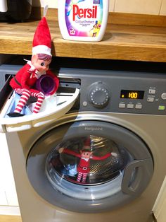 an elf is sitting on top of a washing machine