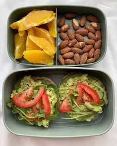 two bowls filled with different types of food on top of a white table covered in fruit and veggies