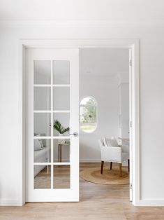 an open door leading into a white living room