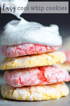 three cookies with white icing on top are stacked up in front of each other