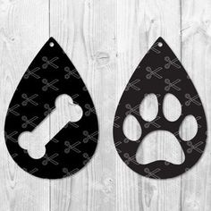 two black and white tear shaped tags with paw prints on them