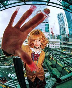 a woman holding up her hand in front of a cityscape with skyscrapers