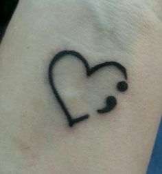 a small tattoo on the wrist of a woman with a heart and stethoscope