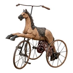 an old fashioned wooden toy horse on wheels