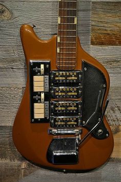 an electric guitar sitting on top of a wooden floor