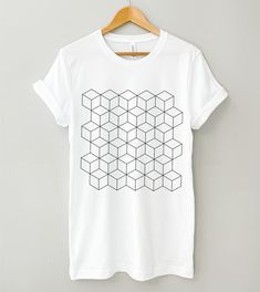 Geometric Graphic Tee, Cubes Shirt, Abstract Shirt, Optical Illusion Shirt, Cube Geometry Tshirt, Line Art Tee, Minimalist Shirt, Modern Tee MADE IN THE U.S.A. PLEASE READ BEFORE PURCHASING Production: 1-4 business days Shipping: 2-5 business days (We have no control over delays related to the postal service) *PLEASE EXPECT DELAYS DURING THE HOLIDAYS* SIZING The Bella + Canvas 3001 tee is a unisex fit, meaning it's a bit more slim through the midsection than a traditional men's tee, but not quite as fitted as a women's tee. Women should size down for a more fitted look and size up for a looser fit. Please be sure to check the size chart photo. We recommend measuring one of your tees at home and comparing it with the size chart.  NO RETURNS, EXCHANGES, OR CANCELLATIONS Because our shirts ar Casual Geometric Graphic Print Tops, White Minimalist Top With Graphic Print, Abstract Shirt, Minimalist Shirt, Minimalist Shirts, Ink In Water, Geometric Graphic, Graphic Apparel, Personalized Notes