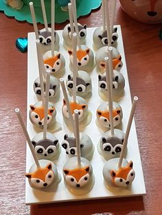 there are many cupcakes that have been decorated with animals and sticks in them