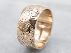 So many wonderful details come together to give this vintage band a rich, textural feel! Crafted of 14 karat yellow gold, this is a great band for stacking or wearing traditional as a wedding band!Metal: 14K Yellow GoldWidth of Band: 8.0 mmHeight off Finger: 1.4 mmRing Size: 6Marks: “<14K>” Stamped on the inside band Fine Jewelry Engraved Ring With Decorative Band, Heirloom Engraved Stackable Ring For Formal Occasions, Heirloom 14k Gold Ring With Decorative Band, Heirloom Ring With Decorative Band In 14k Gold, Heirloom 14k Gold Engraved Bands, 14k Gold Jewelry With Intricate Design For Marriage, Traditional Yellow Gold Jewelry With Decorative Band, 14k Yellow Gold Wedding Ring With Decorative Band, Heirloom 14k Gold Wedding Band Thick Shape