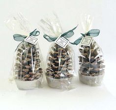 three bags filled with pine cones sitting on top of a table