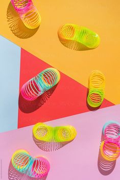 three pairs of neon colored shoes on colorful background