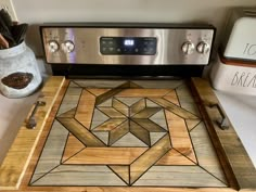 a wooden cutting board sitting on top of a stove