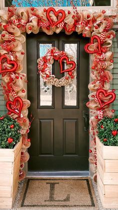 a front door decorated for valentine's day with burlocks and hearts