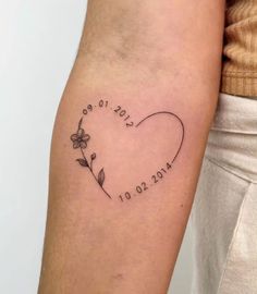 a woman's arm with a tattoo on it that says love and is in the shape of a heart