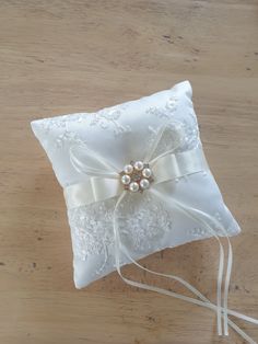 a white ring pillow sitting on top of a wooden table