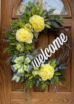 a welcome wreath with yellow flowers on the front door