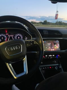 the interior of an audi car with dashboard lights and steering wheel controls, including digital display