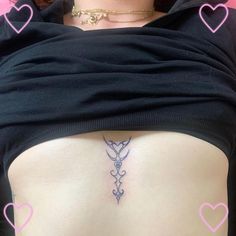 a woman's lower back tattoo with pink hearts around her neck and an arrow on the side