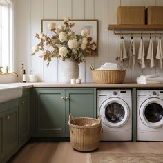 a washer and dryer in a room with green cabinets