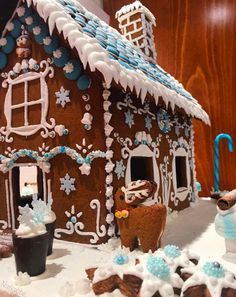 a gingerbread house decorated with icing and decorations