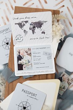 wedding stationery and passport cards on a wooden table