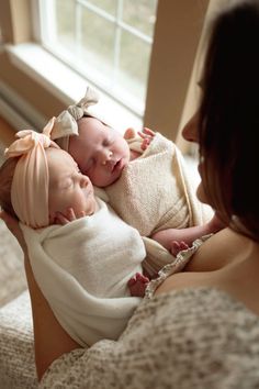 a woman holding a baby in her arms