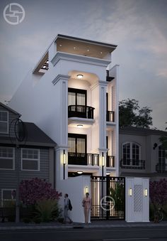 two people standing in front of a white building with balconies on the second floor