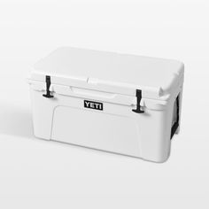 a white yeti cooler sitting on top of a white table next to a black handle