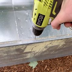 a person using a drill to fix a window