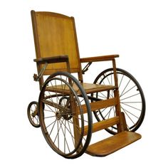 an old fashioned wooden wheelchair with wheels