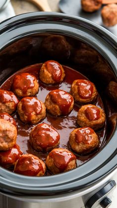 the meatballs are covered with sauce in the slow cooker and ready to be cooked