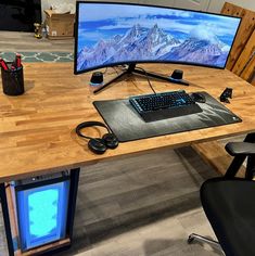 a desk with a computer monitor and keyboard on it, along with other office supplies