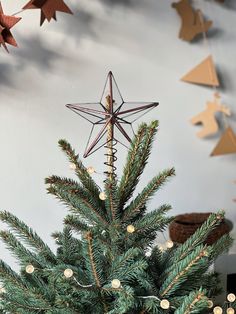 a small christmas tree with a star decoration on top