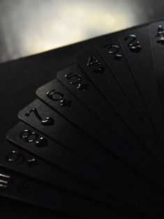 six black cards with numbers on them sitting next to each other