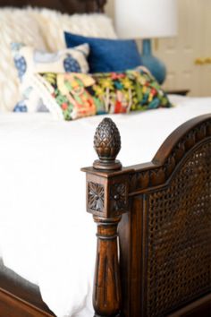 a bed with a wooden headboard and foot board