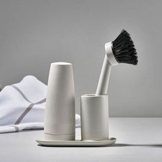 two white toothbrushes sitting next to each other on a table