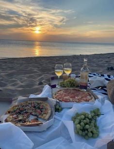 two pizzas and some wine on the beach