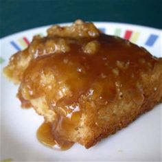 a piece of cake covered in caramel sauce on a plate