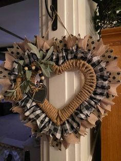 a heart shaped wreath hanging on the front door