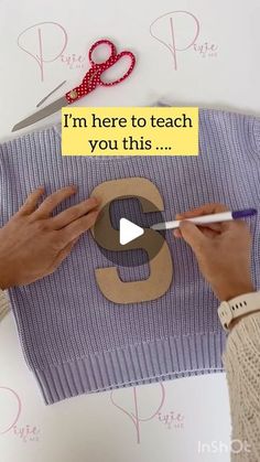 someone is cutting out the number eight on a piece of paper with scissors and yarn