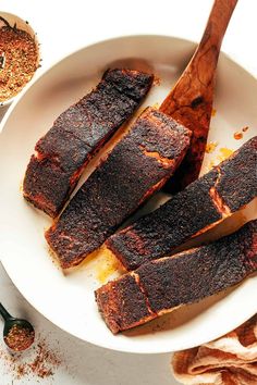 some ribs on a white plate with spices and seasoning