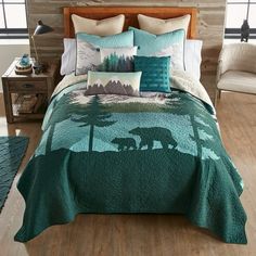 a bed with a bear and mountain scene on it