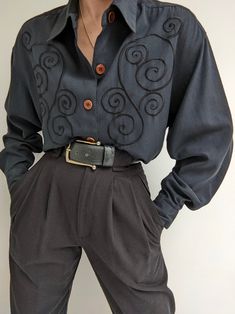 Faded black blouse with a beautiful, muted embroidered design at the front. Blouse has button closures up the front, a collared neckline and pleats at the sleeve cuffs. 100% rayon Tag reads TOTOnKo Recommended for size xs-l, depending on the desired fit. Modeled on an extra small frame. Please refer to the measurements listed below: Measures approximately: 20" shoulder to shoulder / 42" bust / 21" sleeve length / 28" shoulder to hemline There is some incredibly minor pilling. If you would like a Oc Clothes, Black Embroidered Blouse, Lady Outfits, 1970s Clothing, Pretty Clothing, Dr Closet, Knit Outerwear, Character Poses, Formal Casual